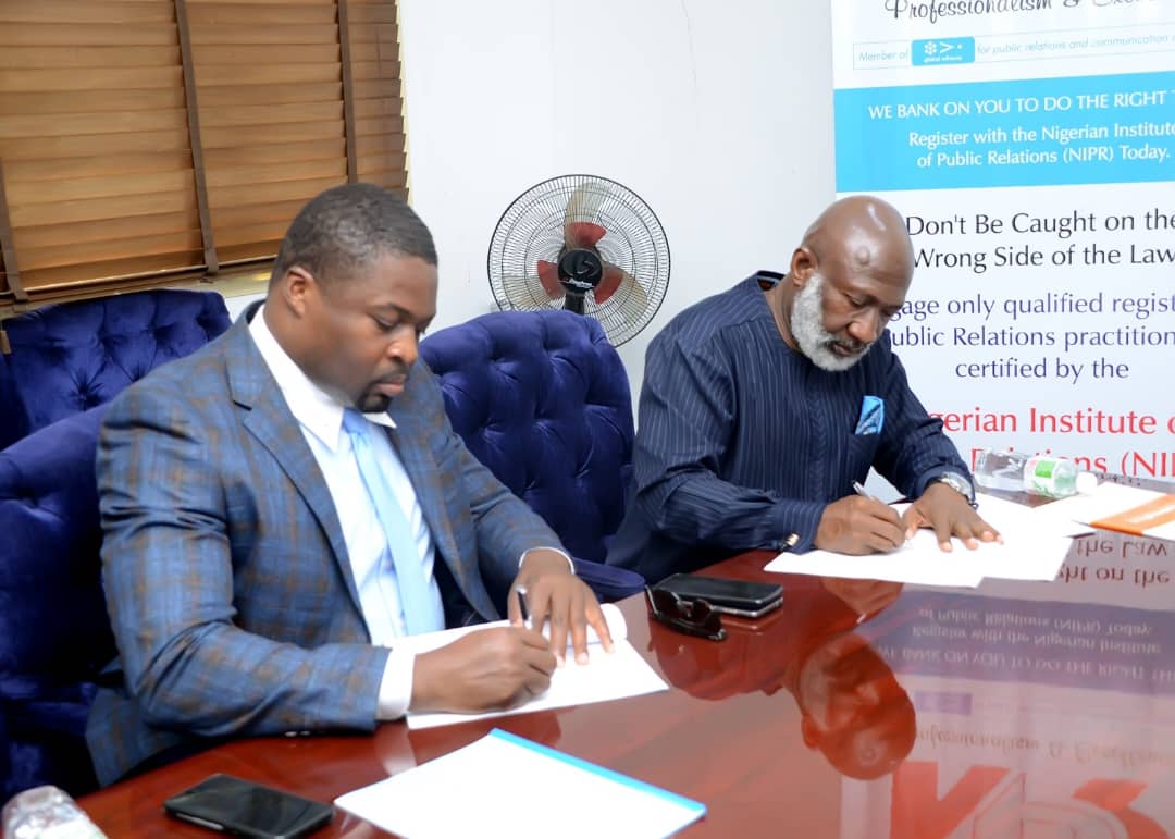 Franlyn Ginger-Eke (l) and Hassan Abdul signing for The Rainbow Strategy