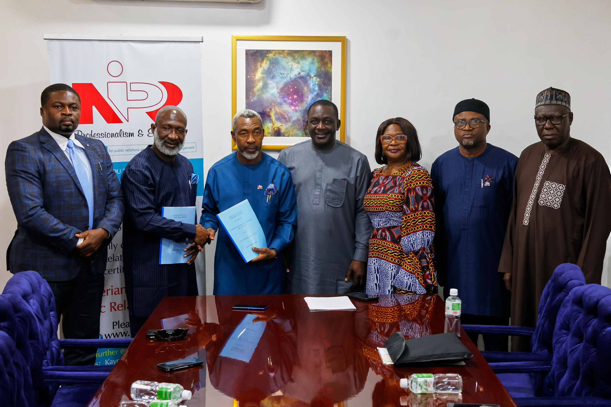 The Rainbow Strategy team, NIPR President Dr. Ike Neliaku fnipr (3rd left); Vice President Emmanuel Dandaura fnipr (4th left) and other representatives of the NIPR at the signing event