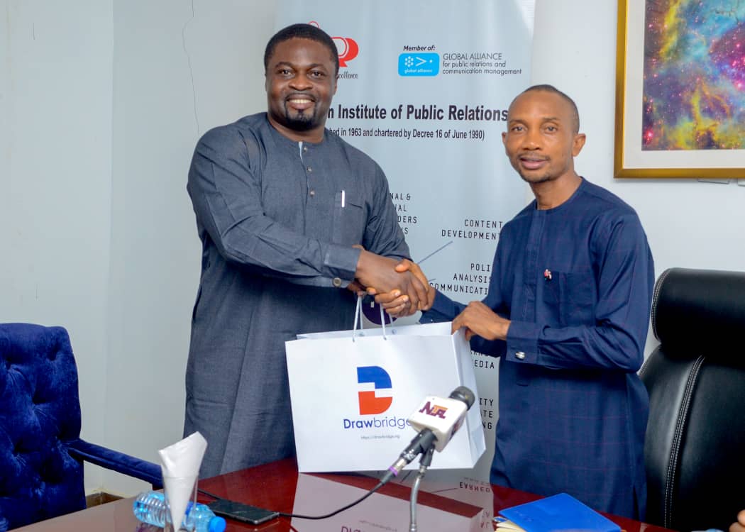 Drawbridge CEO Hassan Abdul presenting a gift to the FCT Chairman, Mr. Stanley Ogadigo fnipr during the courtesy visit